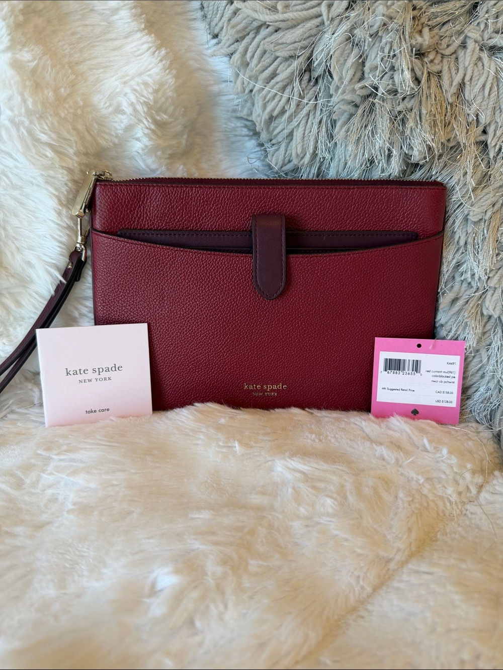 kate spade Burgundy Pebbled Leather Wristlet Clutch with Gold Tone Logo